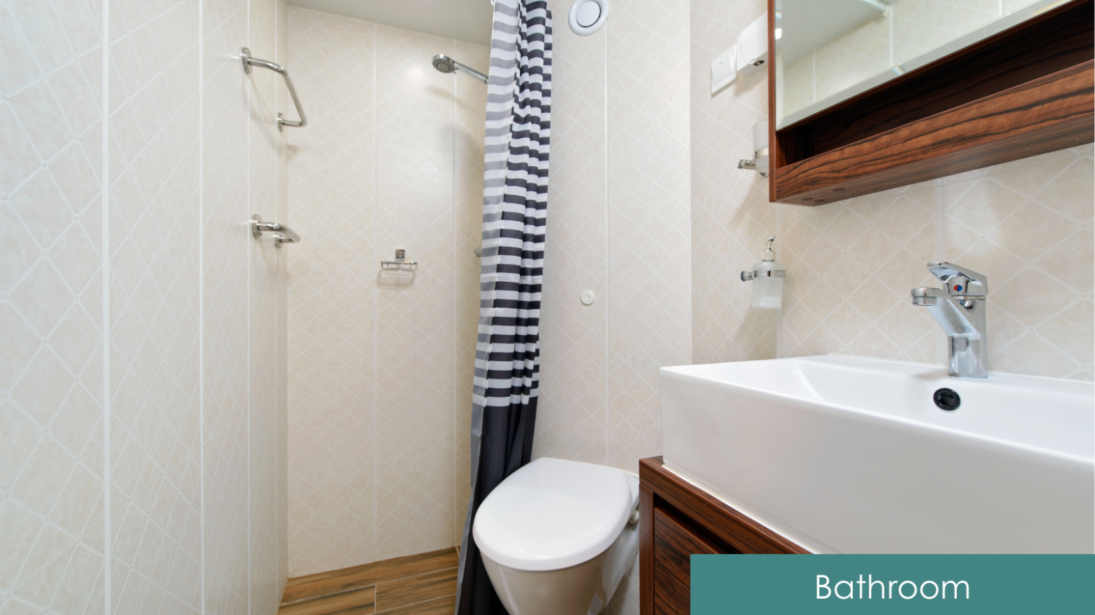 Compact bathroom with sink, toilet, and striped shower curtain.