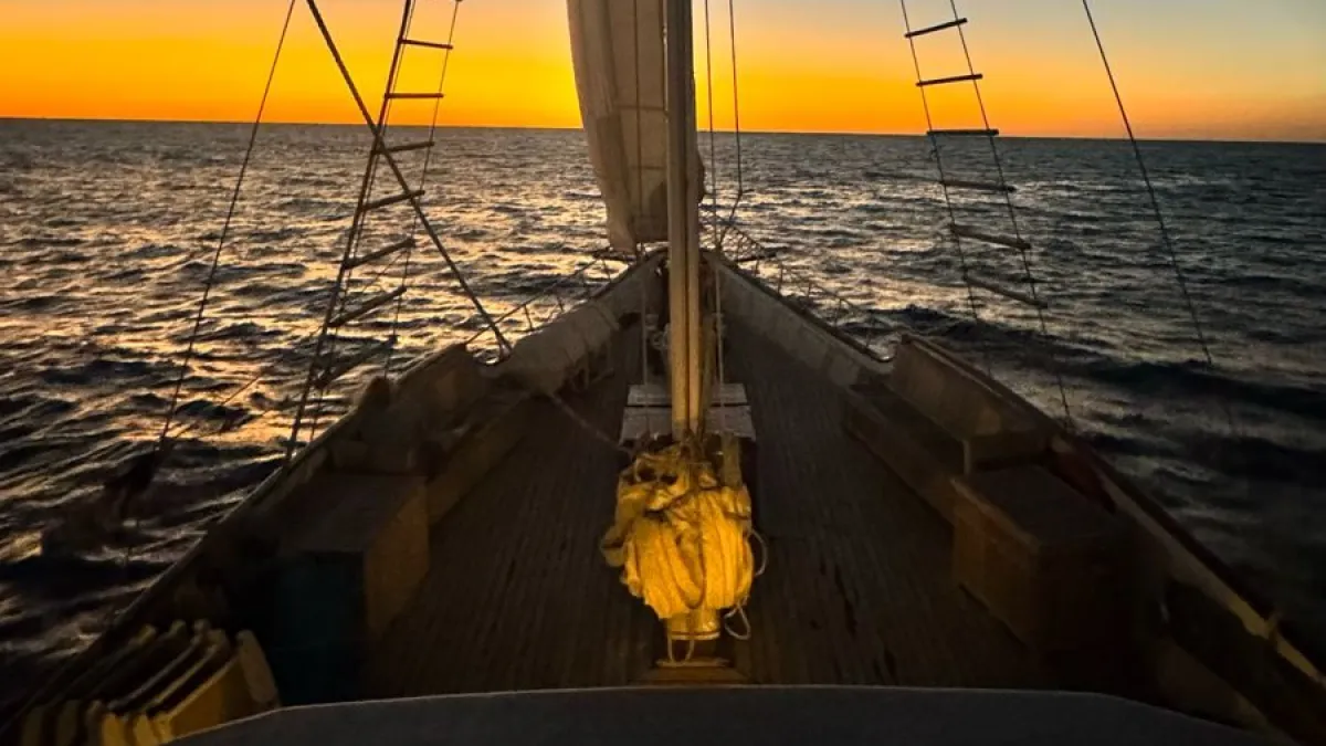 The top deck of a sailboat on sunset.