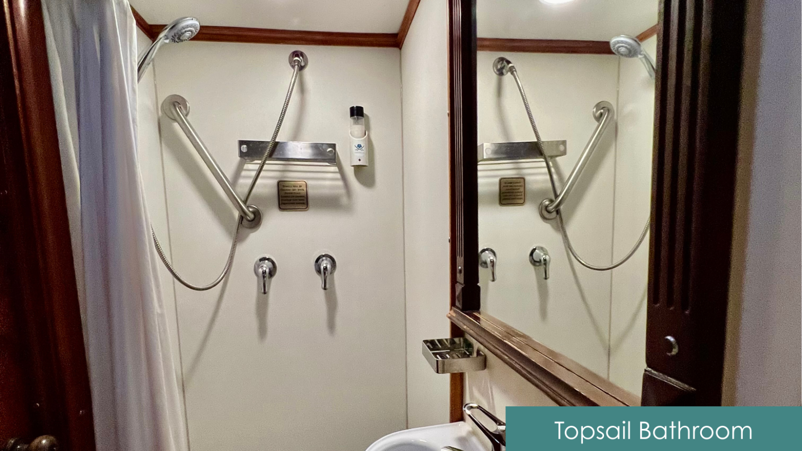 Compact bathroom with shower, mirror, and toiletries.